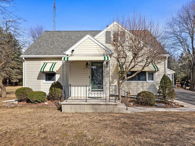 view of front of house with roof with shingles