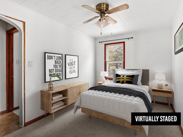 bedroom featuring arched walkways, ceiling fan, and baseboards