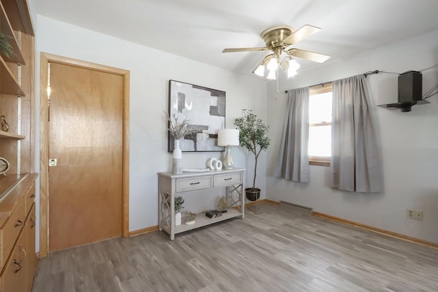 bedroom with light wood-style flooring, baseboards, and ceiling fan