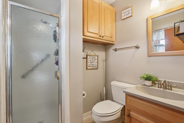 full bathroom featuring a shower stall, vanity, and toilet