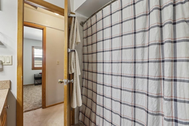 full bath featuring vanity and a shower with shower curtain