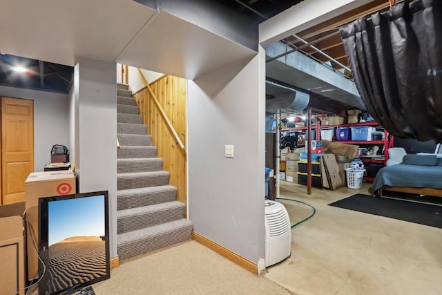 finished basement with stairway and baseboards