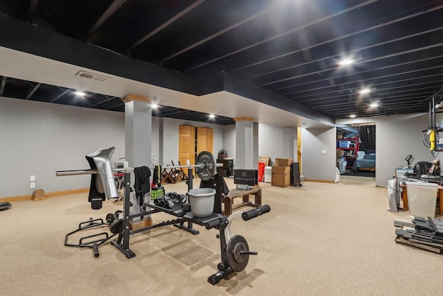 workout area with visible vents, baseboards, and carpet floors