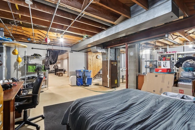 bedroom with heating unit and concrete flooring