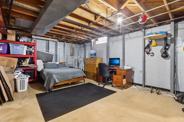 bedroom featuring electric panel and concrete flooring