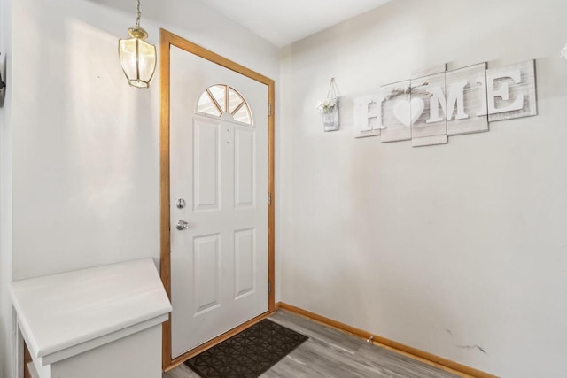 foyer featuring baseboards and light wood finished floors