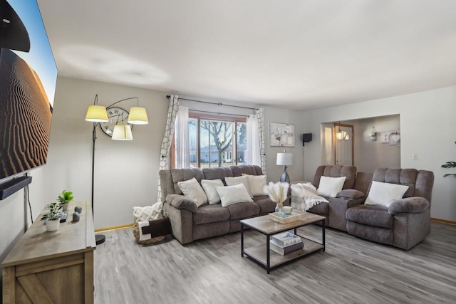 living room featuring baseboards and wood finished floors