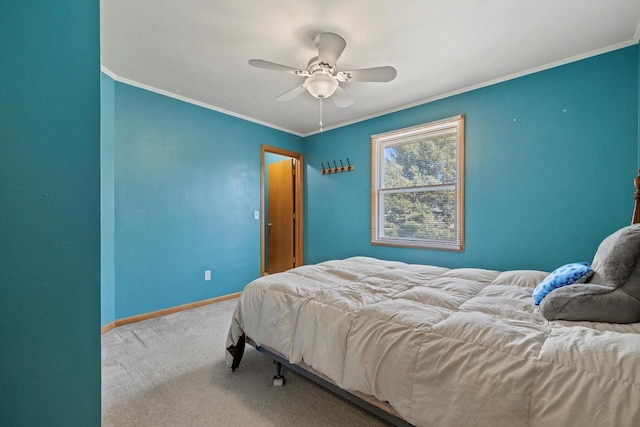 bedroom with carpet flooring, ceiling fan, baseboards, and ornamental molding