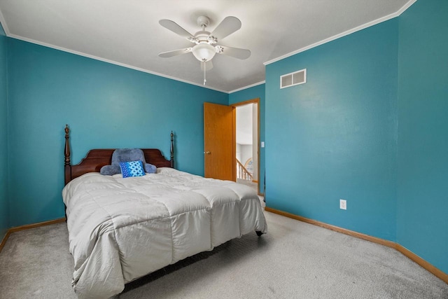 carpeted bedroom with crown molding, baseboards, and visible vents