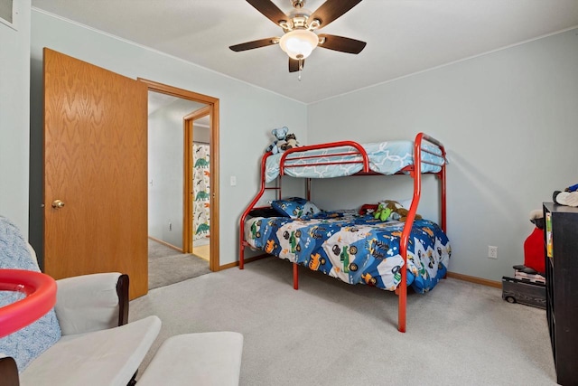 carpeted bedroom with visible vents, baseboards, and a ceiling fan