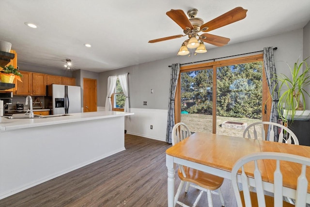 interior space with ceiling fan, a wainscoted wall, dark wood finished floors, and recessed lighting