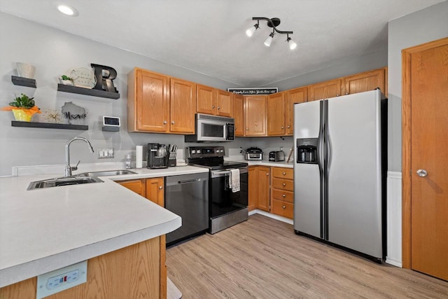 kitchen featuring open shelves, a sink, stainless steel appliances, light countertops, and light wood-style floors