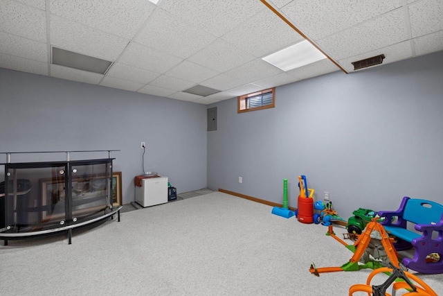 recreation room with electric panel, visible vents, a paneled ceiling, and carpet floors