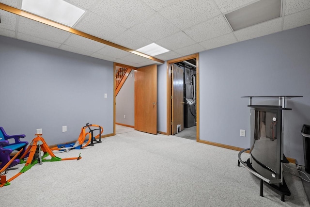 rec room with carpet flooring, a paneled ceiling, and baseboards