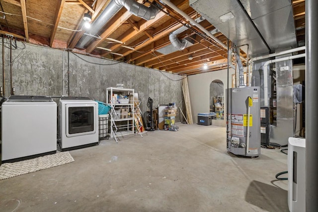 unfinished basement featuring gas water heater, heating unit, and washing machine and clothes dryer