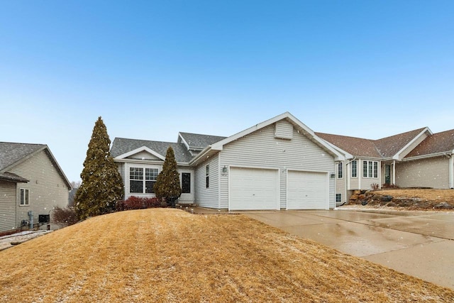 ranch-style house with driveway, a front lawn, and an attached garage