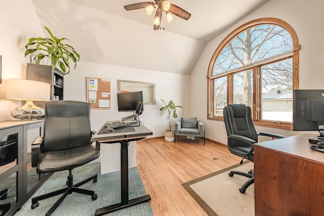 office featuring lofted ceiling, wood finished floors, baseboards, and ceiling fan