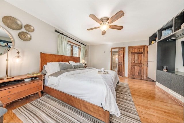 bedroom featuring light wood finished floors and ceiling fan