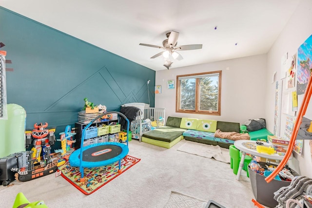 recreation room with carpet floors and ceiling fan