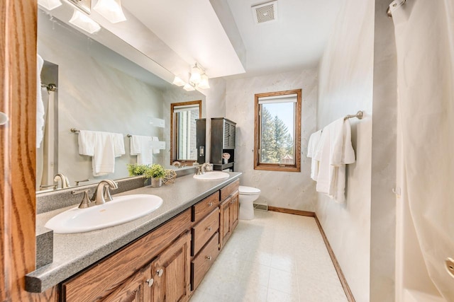 full bath with a sink, visible vents, baseboards, and toilet