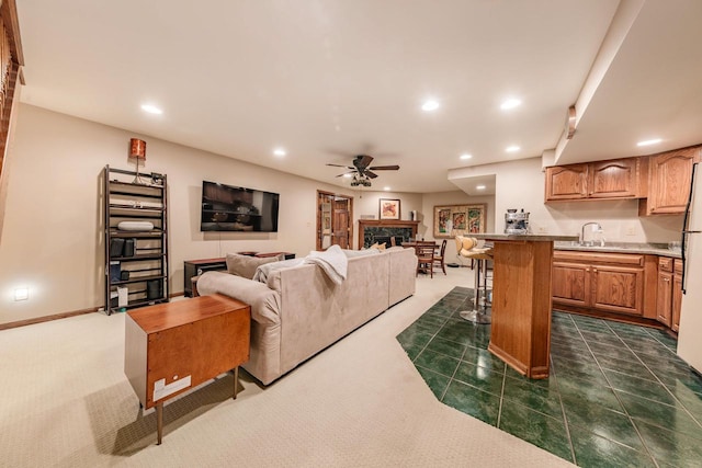 living area featuring recessed lighting, a fireplace, baseboards, and a ceiling fan