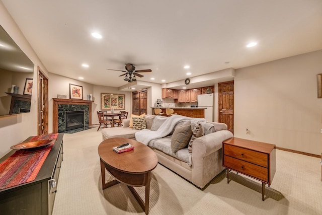 living area with light carpet, recessed lighting, baseboards, and a high end fireplace