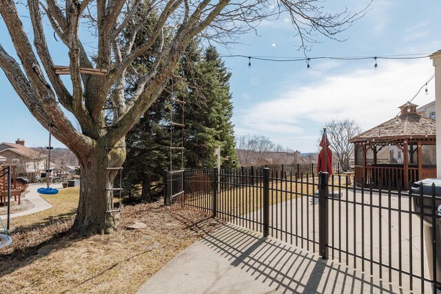 view of gate featuring a gazebo and fence