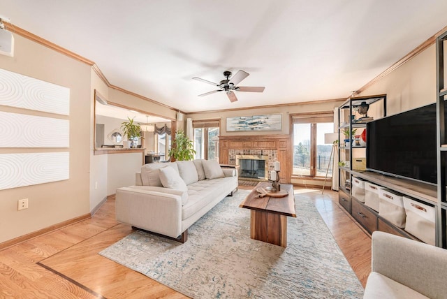 living room featuring plenty of natural light, a fireplace, and light wood finished floors