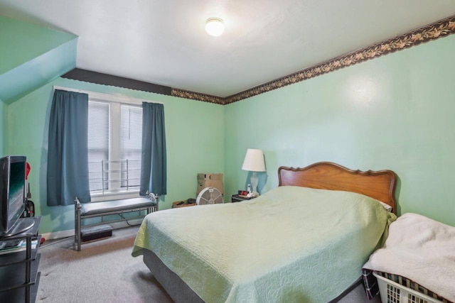 bedroom with lofted ceiling and carpet floors