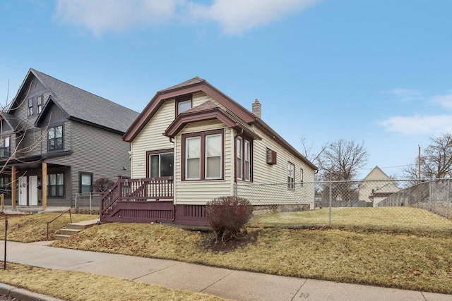 view of front of house featuring a front yard, fence, crawl space, and a chimney