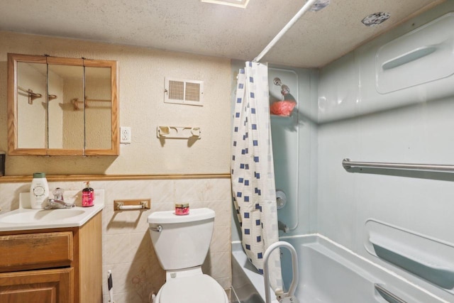 full bath with visible vents, toilet, tile walls, shower / tub combo, and vanity