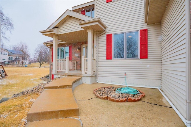 doorway to property with covered porch