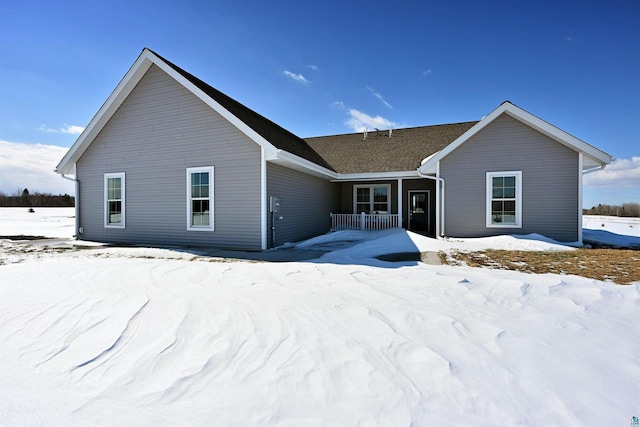 snow covered property featuring covered porch