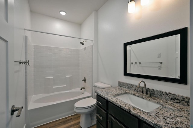 full bathroom featuring shower / bathtub combination, toilet, vanity, and wood finished floors