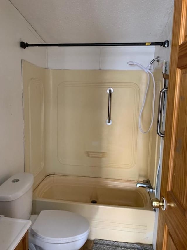 full bath with shower / bath combination, toilet, vanity, and a textured ceiling