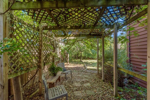 view of yard with fence and a pergola