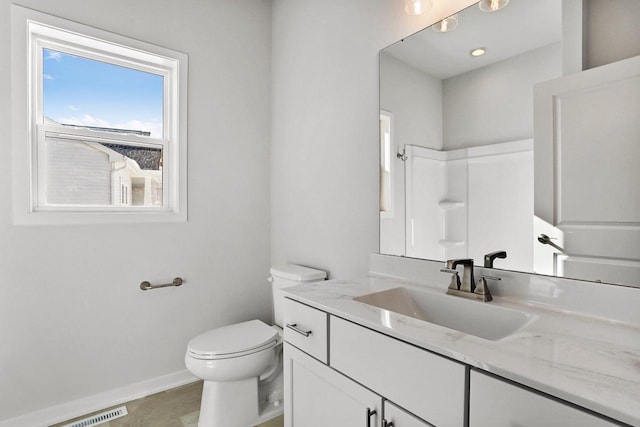 full bath with visible vents, baseboards, toilet, vanity, and a shower