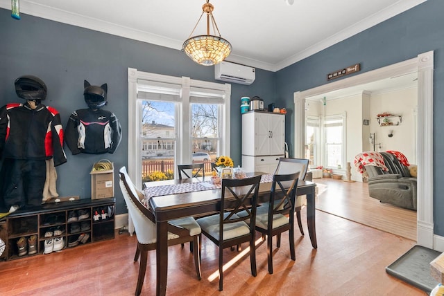 dining area featuring wood finished floors, plenty of natural light, ornamental molding, and a wall mounted AC