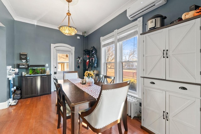 dining room featuring plenty of natural light, ornamental molding, and a wall unit AC