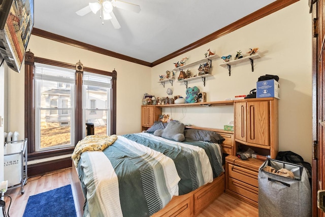 bedroom featuring a ceiling fan, light wood-style floors, and ornamental molding