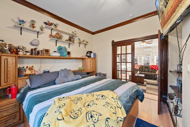 bedroom featuring ornamental molding and wood finished floors