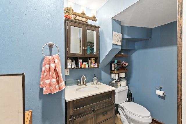 bathroom with toilet and vanity