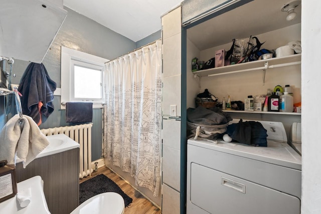 full bathroom with washer / dryer, radiator heating unit, and wood finished floors