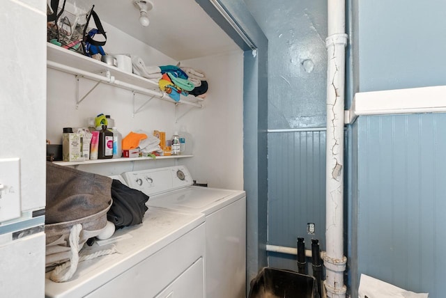 laundry room with wainscoting, laundry area, and washing machine and dryer