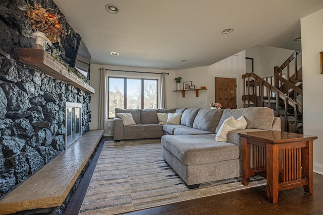 living room with recessed lighting, stairway, wood finished floors, and a fireplace