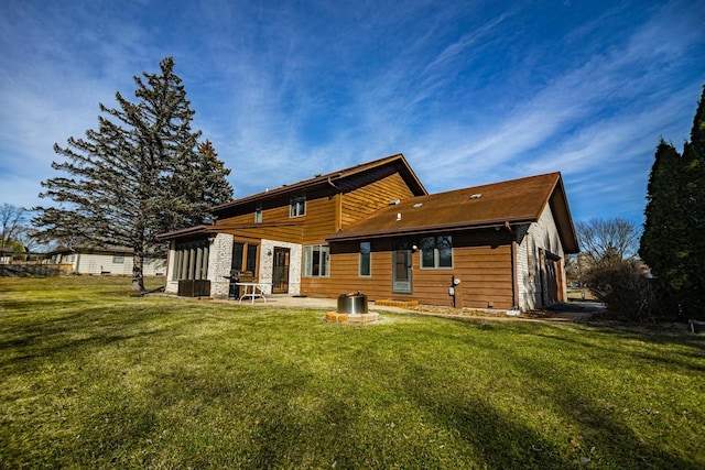 rear view of property with a yard, a patio, and central AC