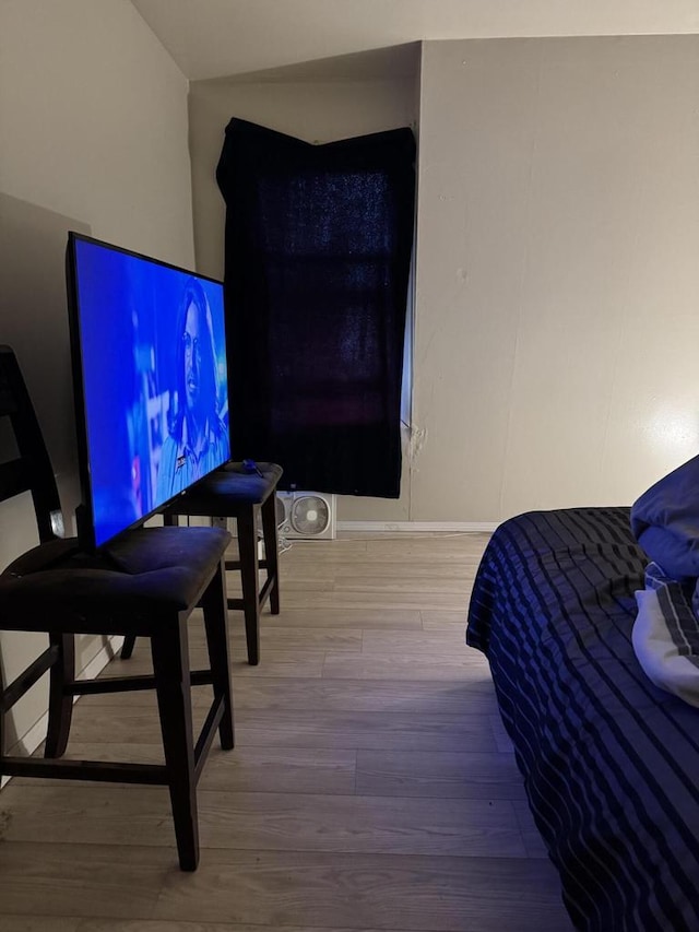 bedroom featuring baseboards and wood finished floors