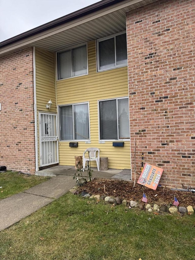 property entrance with brick siding