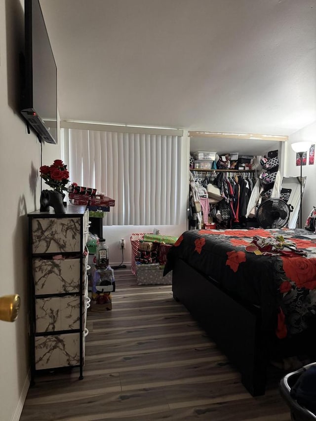 bedroom featuring baseboards and wood finished floors