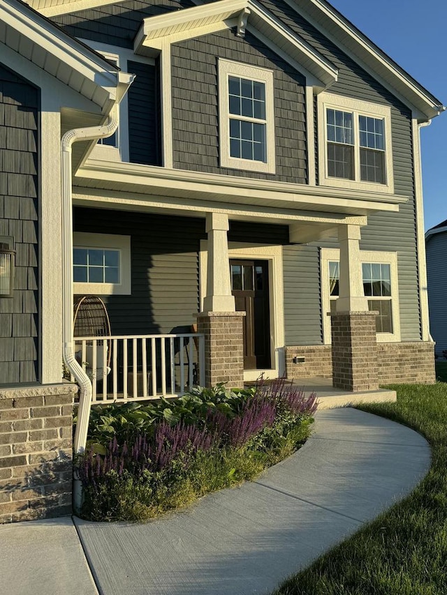 view of front of house with brick siding and covered porch